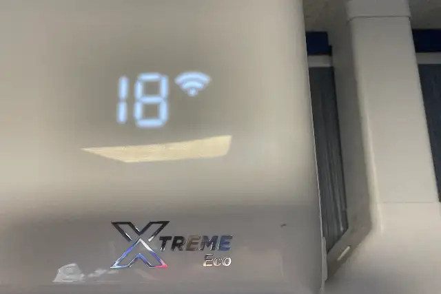 Close-up of an air conditioning unit display showing the set temperature