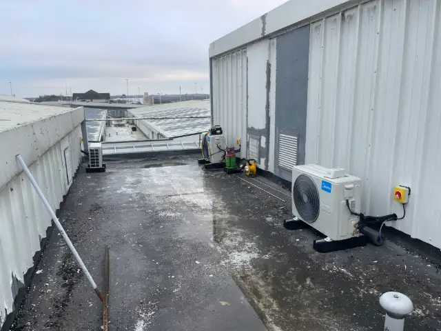 Outdoor air conditioning unit on the flat roof of a commercial building