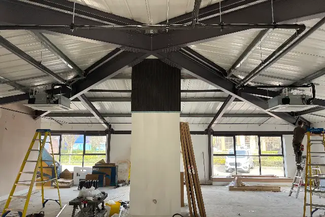 Commercial air conditioning being installed in a large open-plan commercial unit