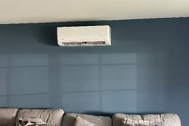 Domestic air conditioning unit installed above the sofa in a family living room