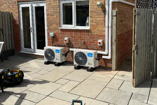 Two outdoor air conditioning units serving several rooms, installed on a rear patio
